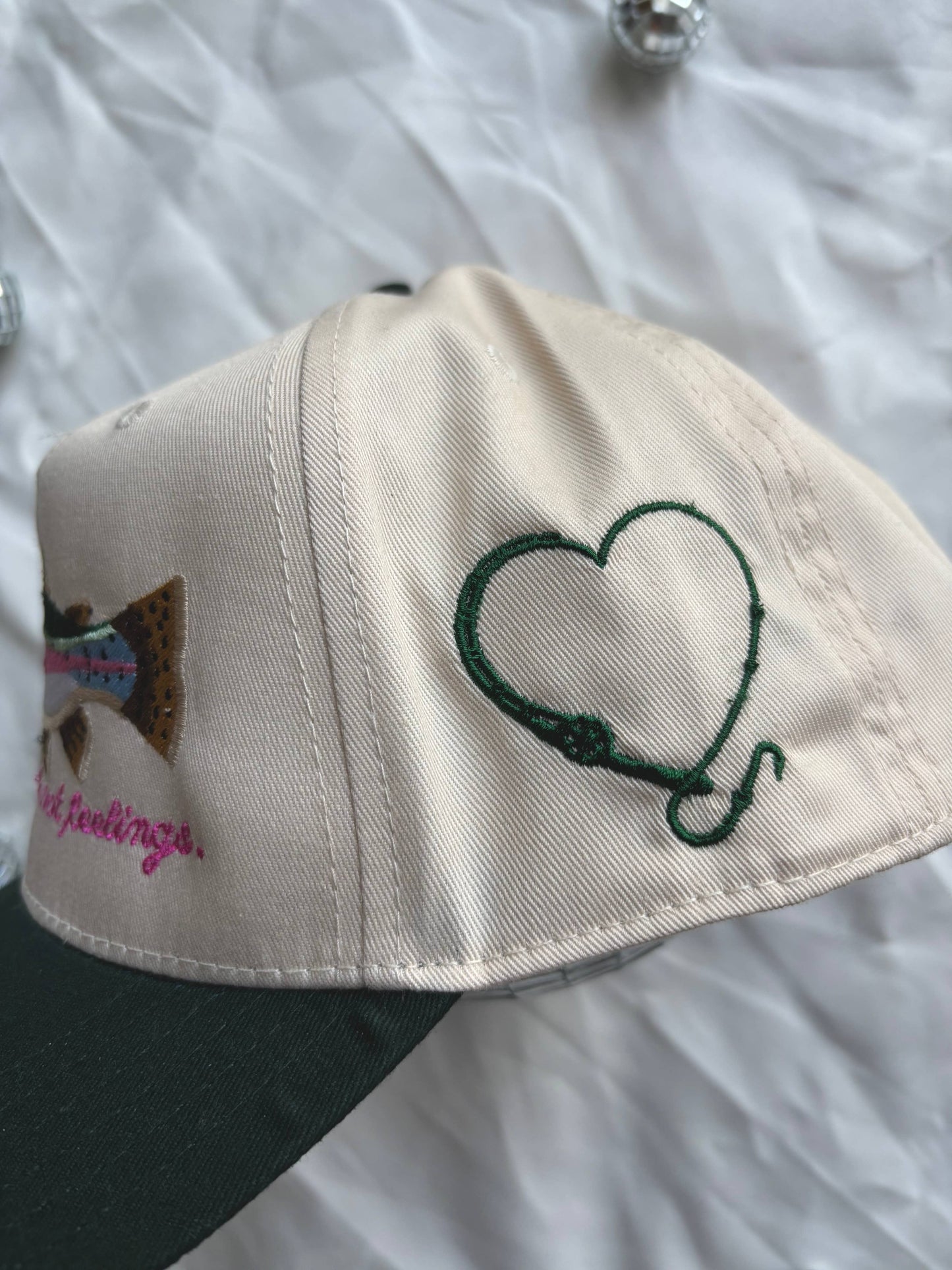 Cap with heart design and text on a white background