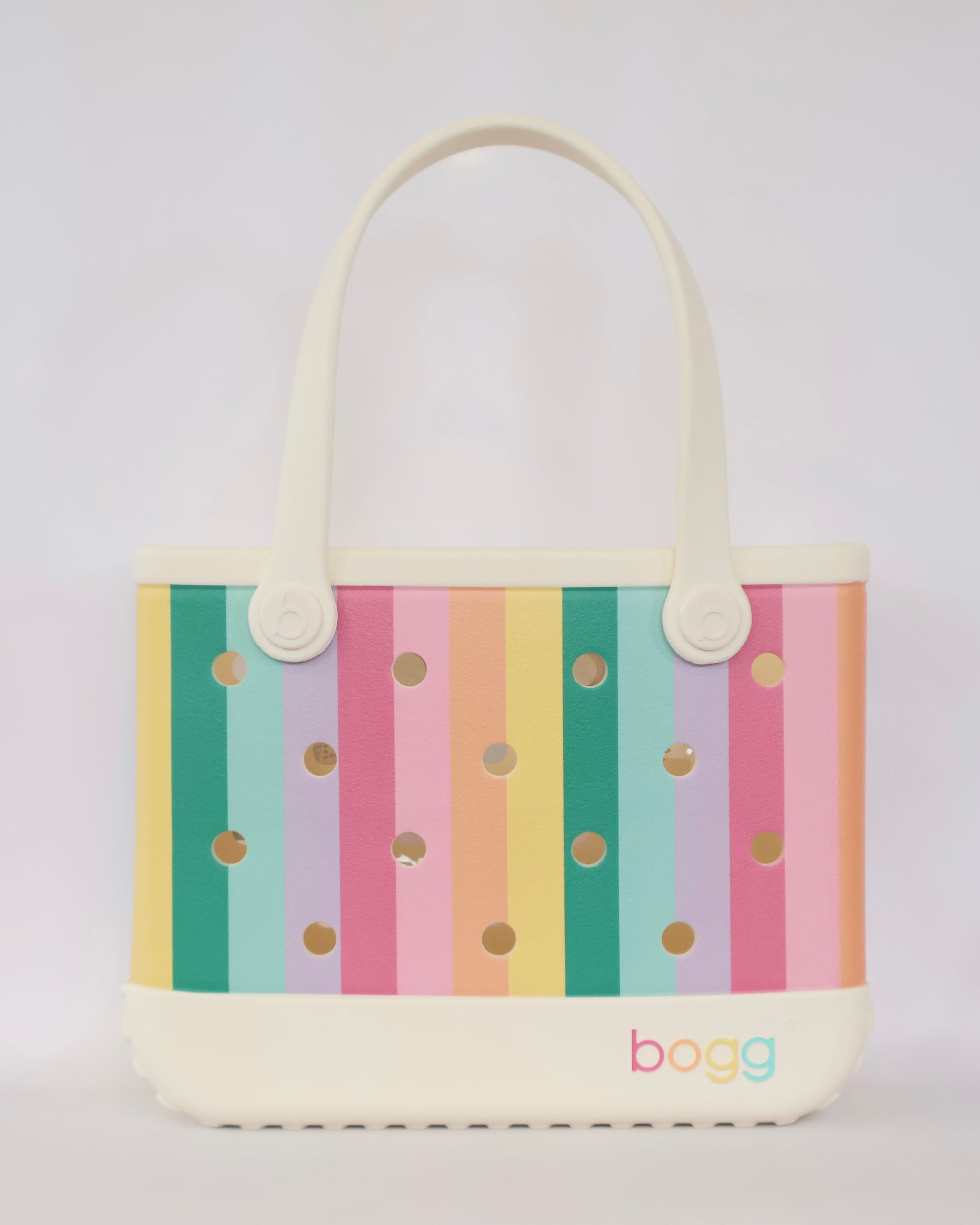Tote bag with colorful striped pattern and polka dots on a light gray background