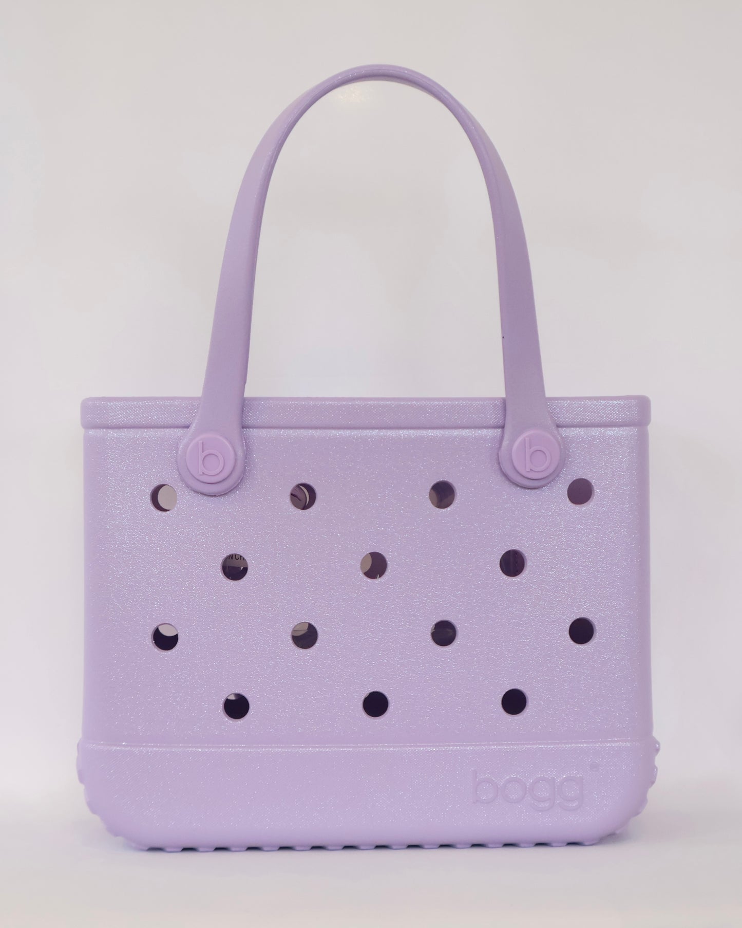 Purple handbag with black polka dots on a white background