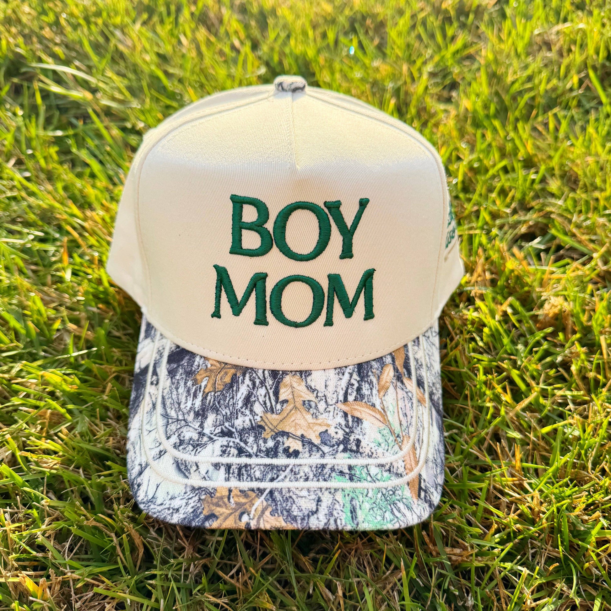 Cap with 'BOY MOM' text on grass