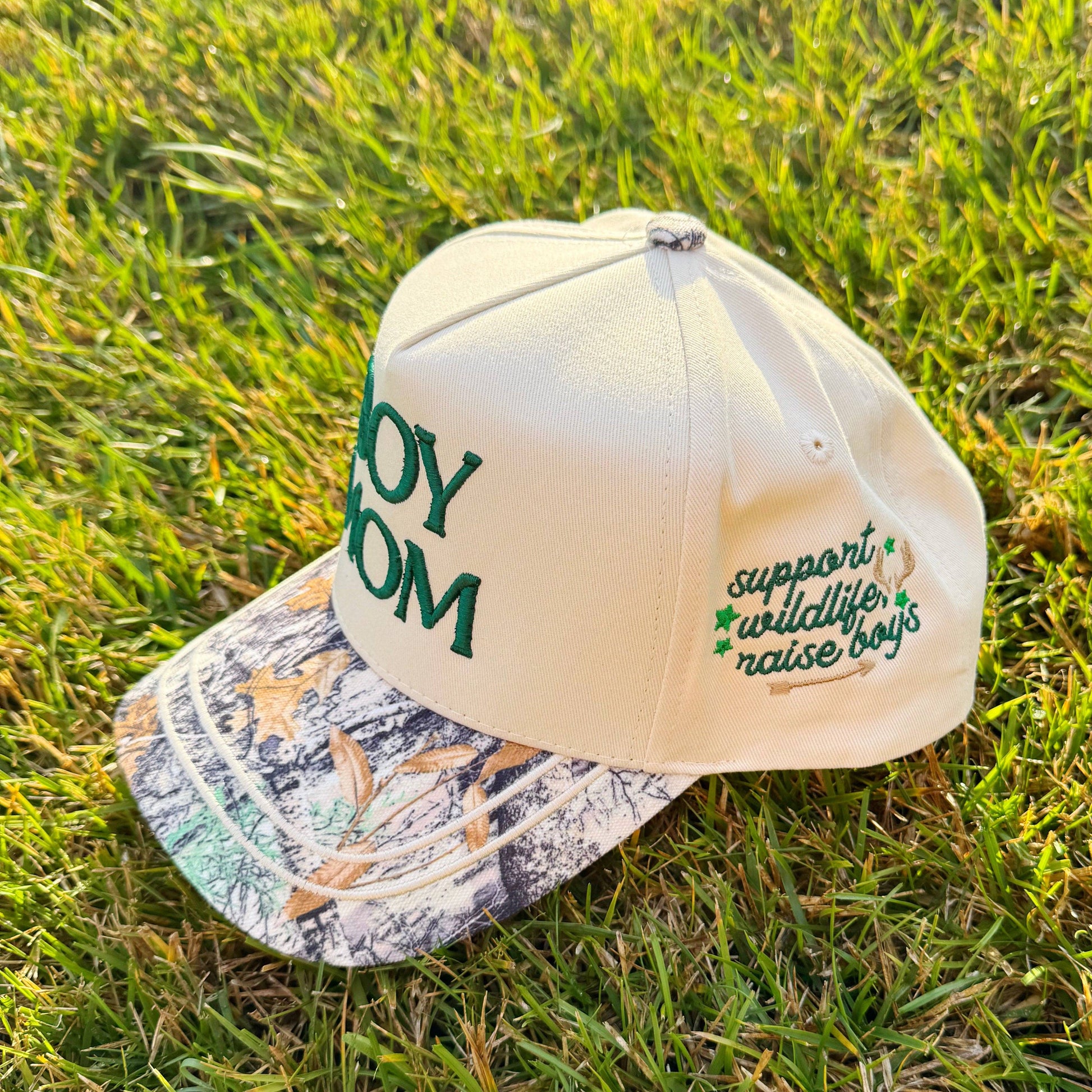 Beige cap with green text on a grassy background