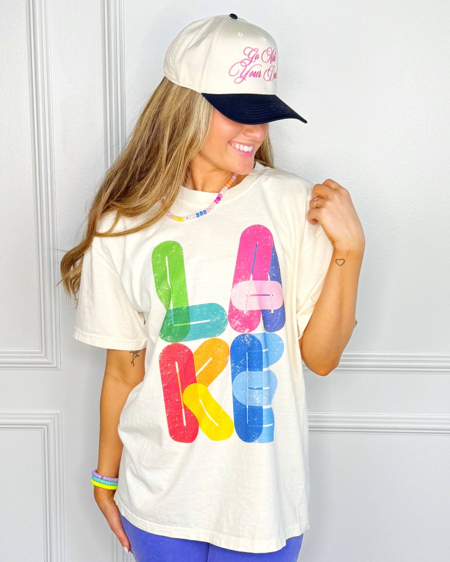 Person wearing a colorful 'LAKE' t-shirt 