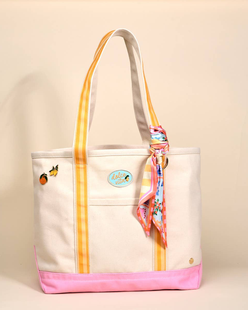 Tote bag with colorful accents and a scarf on a beige background