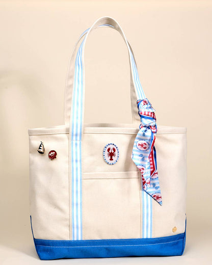 Beige tote bag with blue accents and decorative elements on a beige background