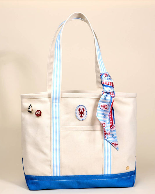 Beige tote bag with blue accents and decorative elements on a beige background