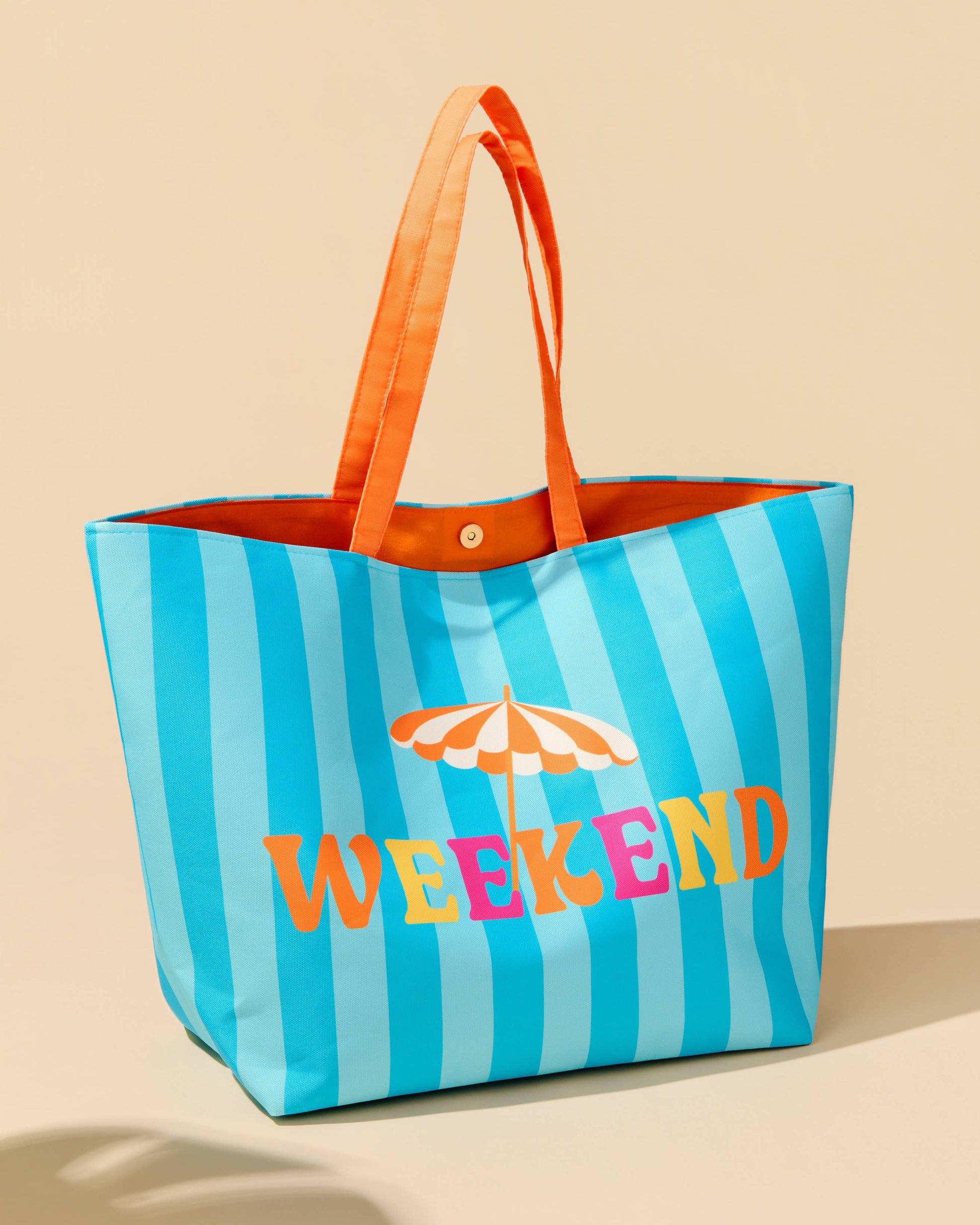 Striped tote bag with 'Weekend' text and umbrella graphic on a beige background