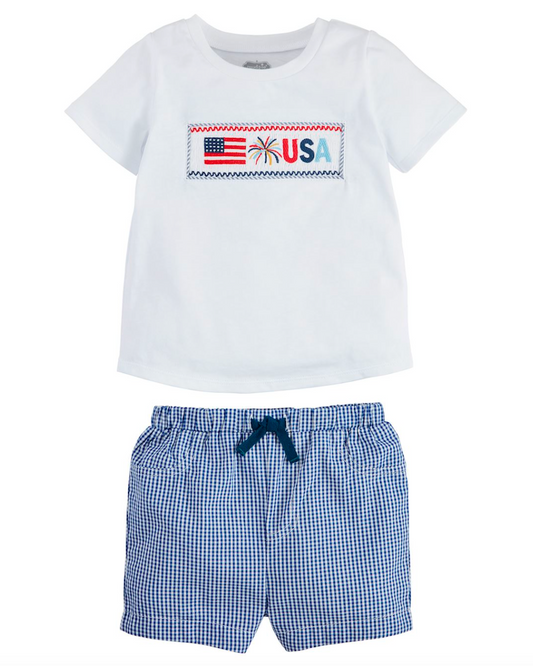 White t-shirt with USA flag design and blue checkered shorts on a white background