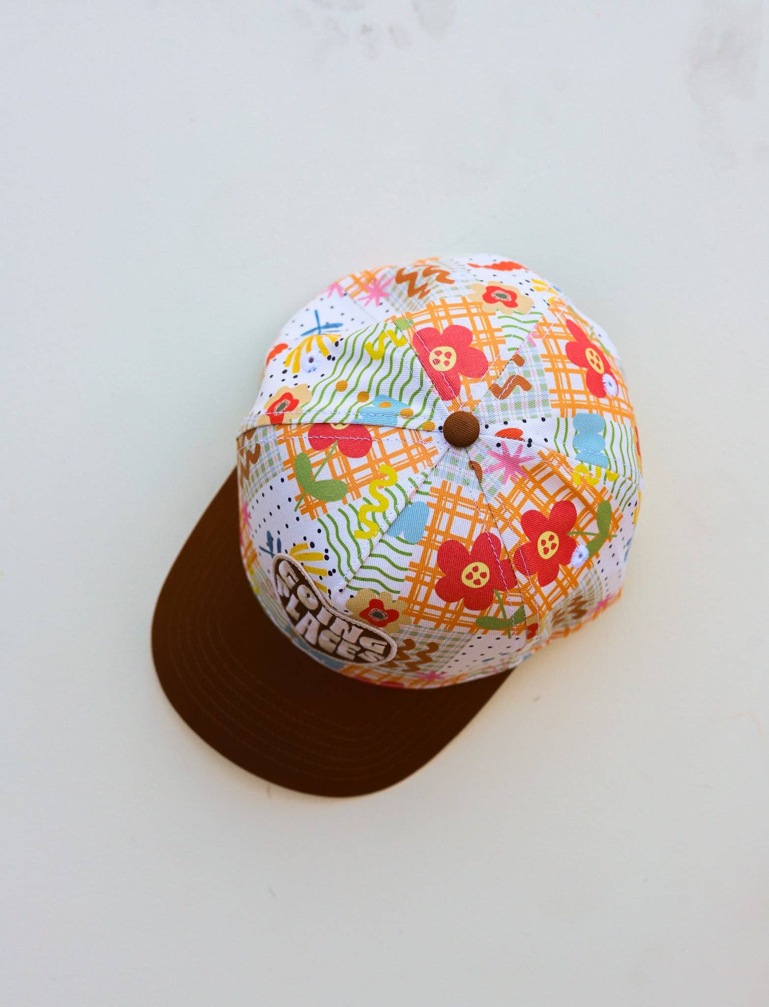 Colorful fabric-covered baseball cap on a white background