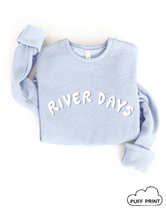Light blue sweatshirt with 'RIVER DAYS' text on a white background