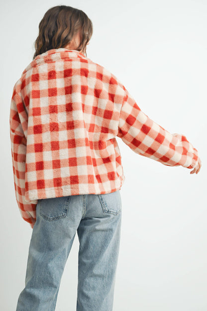 Person wearing a red and white checkered jacket on a white background