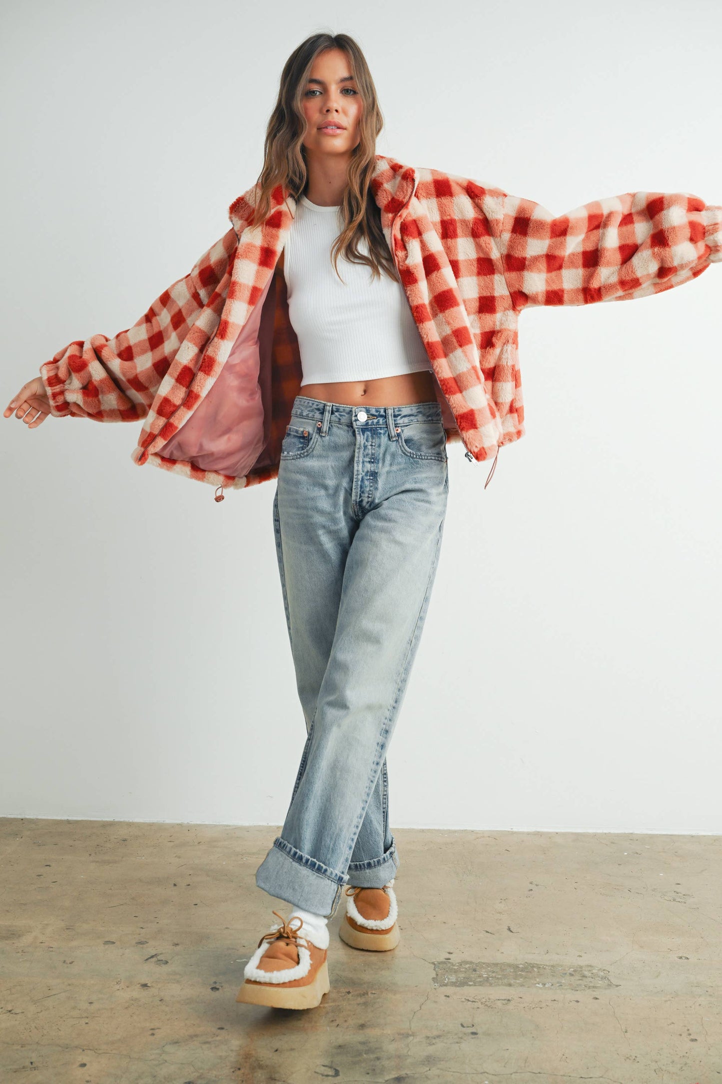 Person wearing a red and white checkered jacket on a white background