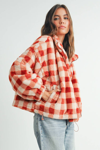 Person wearing a red and white checkered jacket on a white background