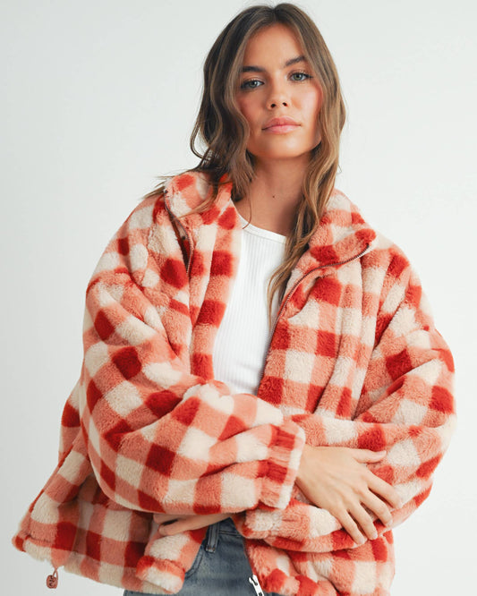 Person wearing a red and white checkered jacket on a white background