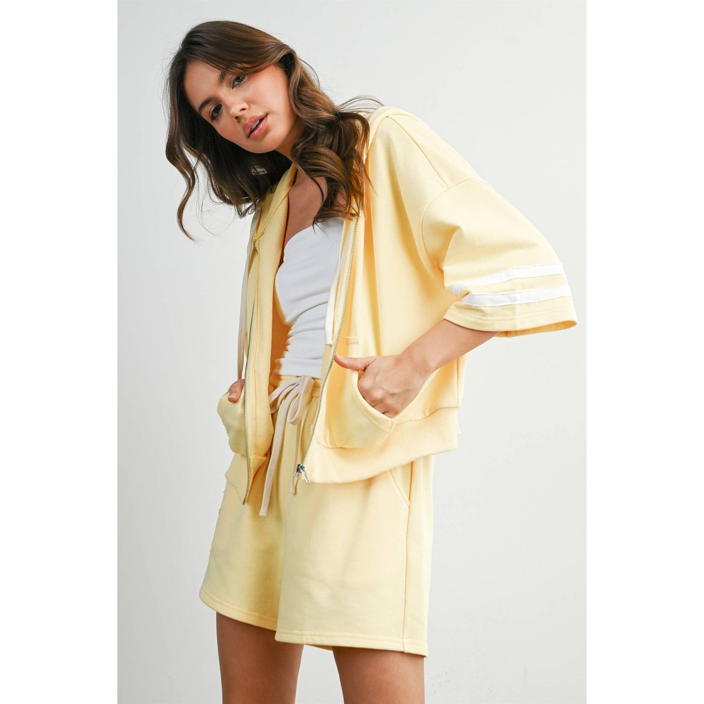 Woman wearing a yellow outfit with a white background