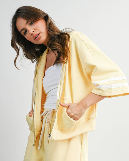 Woman wearing a yellow outfit with a white background