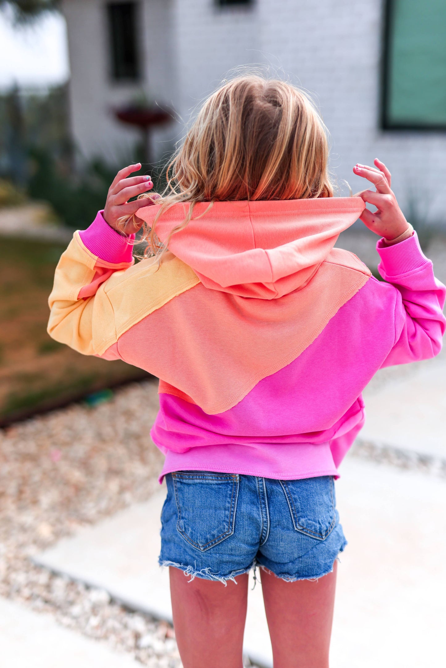Person wearing a colorful hoodie with a blurred background