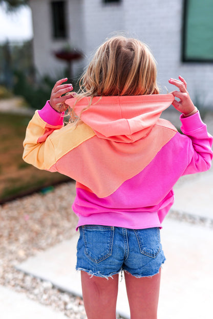 Person wearing a colorful hoodie with a blurred background